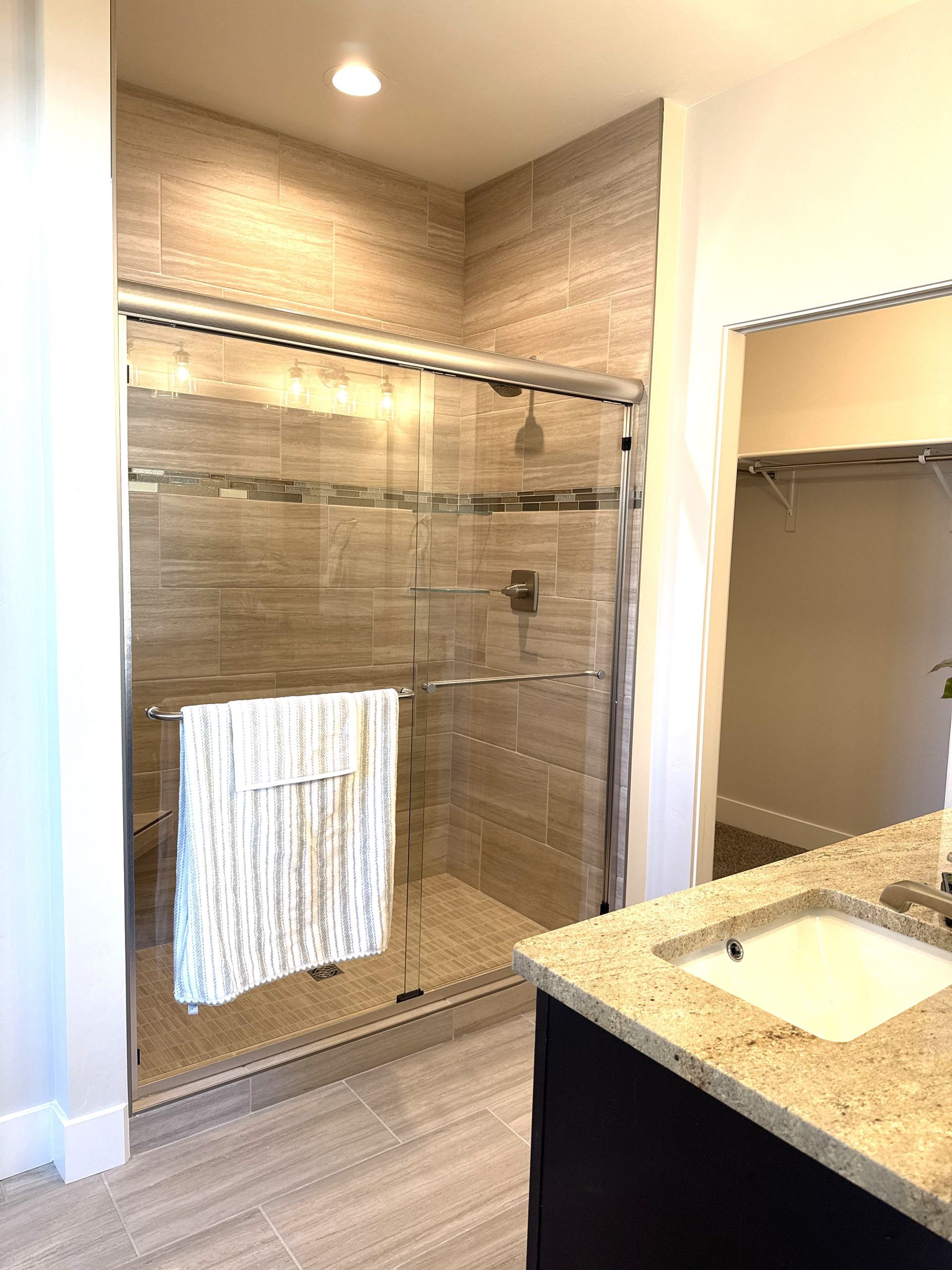 Tiled walk-in shower in the primary bathroom at 3316 Pyrus St.