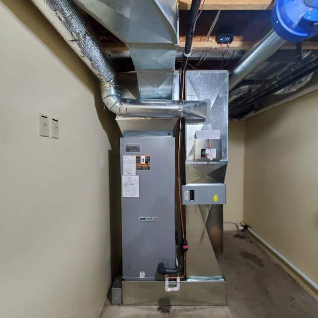 a room with a heater and a fan on the wall