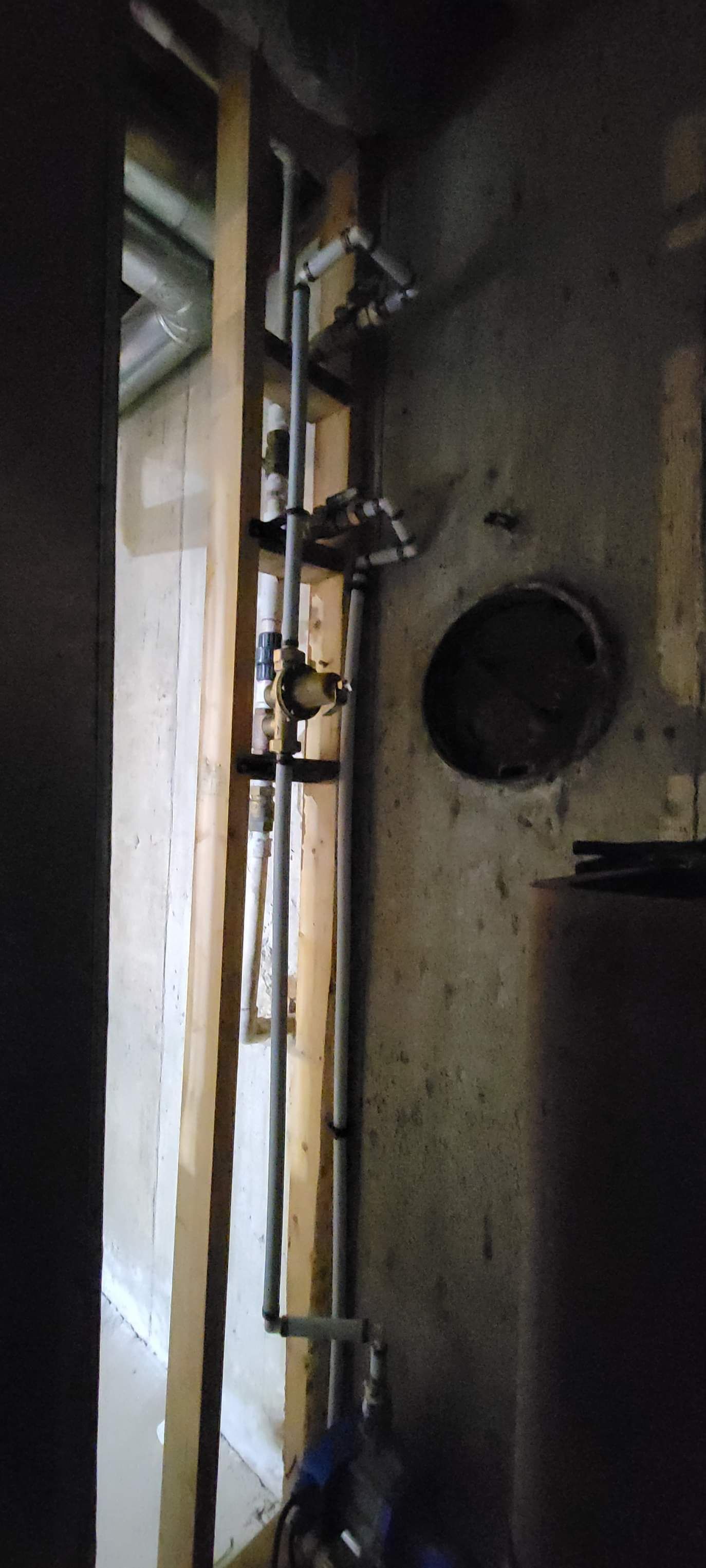 a pipe is hanging from a wall in a dark room .
