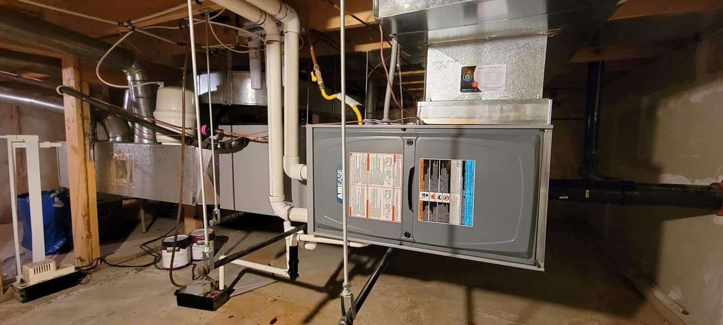 a basement with a heating and air conditioning system hanging from the ceiling .