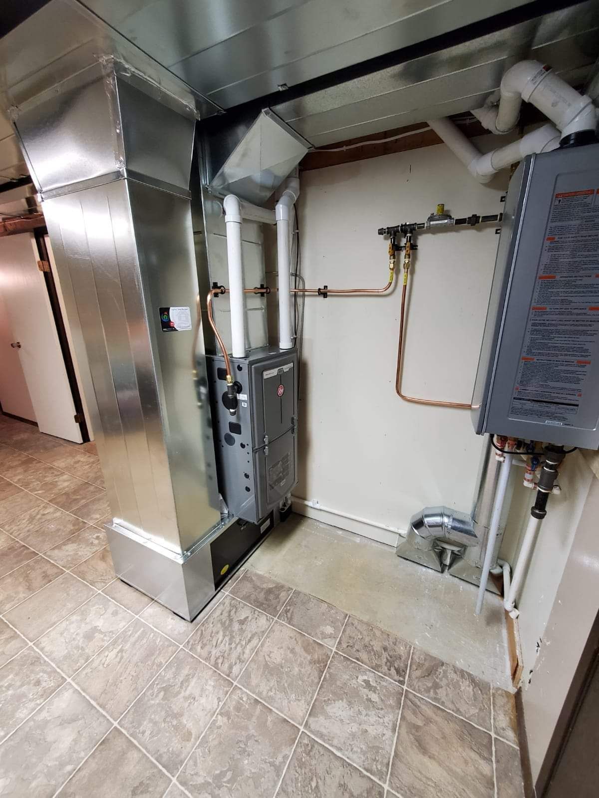 a room with a heater and pipes in it .