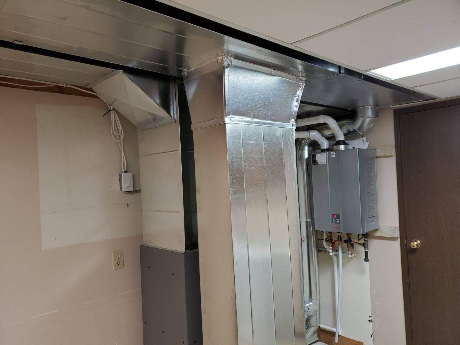 a room with a lot of pipes coming out of the ceiling .