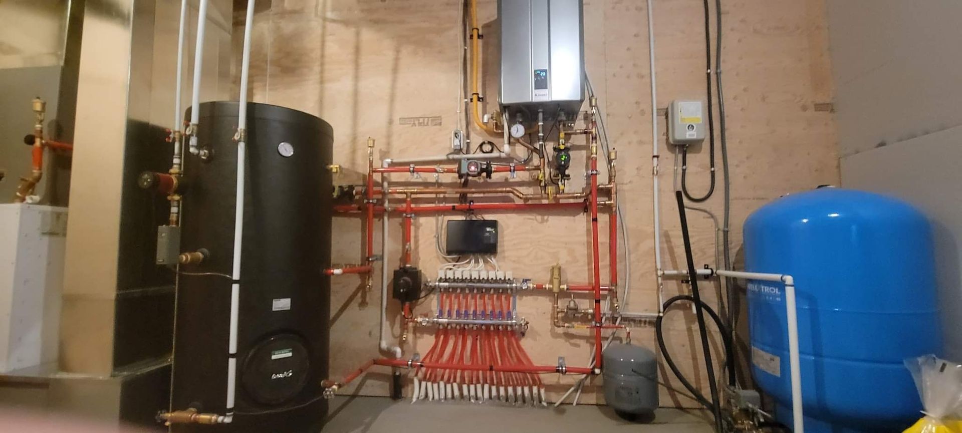 a room with a lot of pipes and a heater .