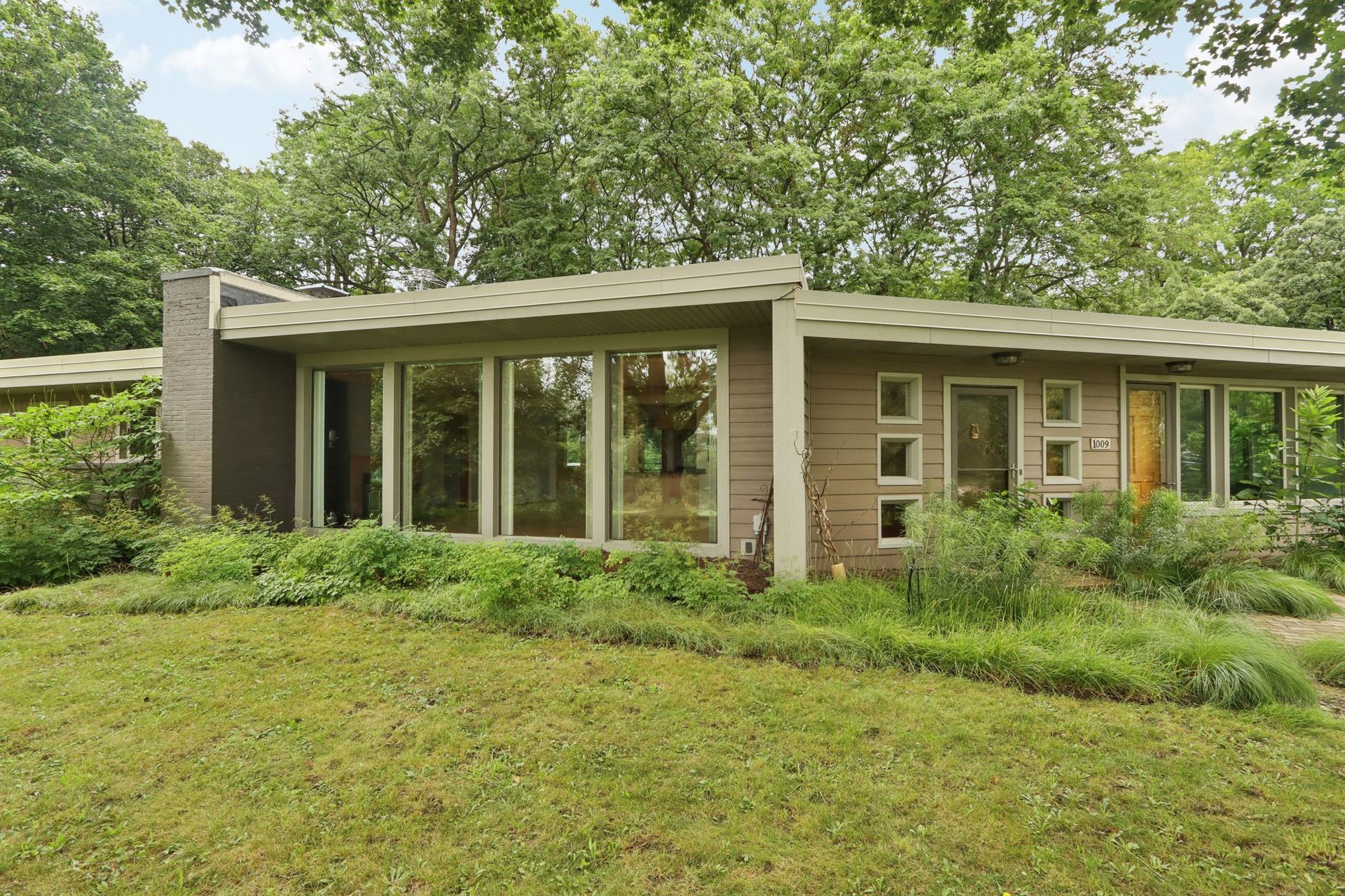 Modern, single-story house in Burlington, WI with large windows.