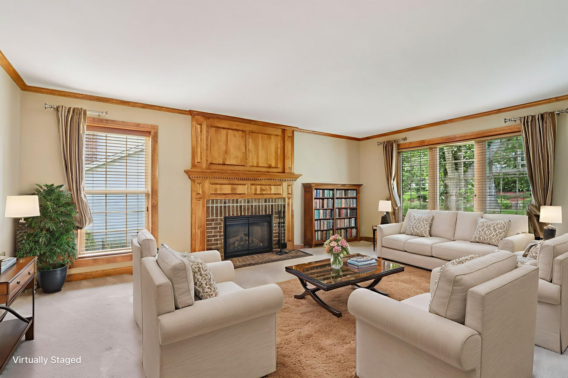 Living room with fireplace and large windows.