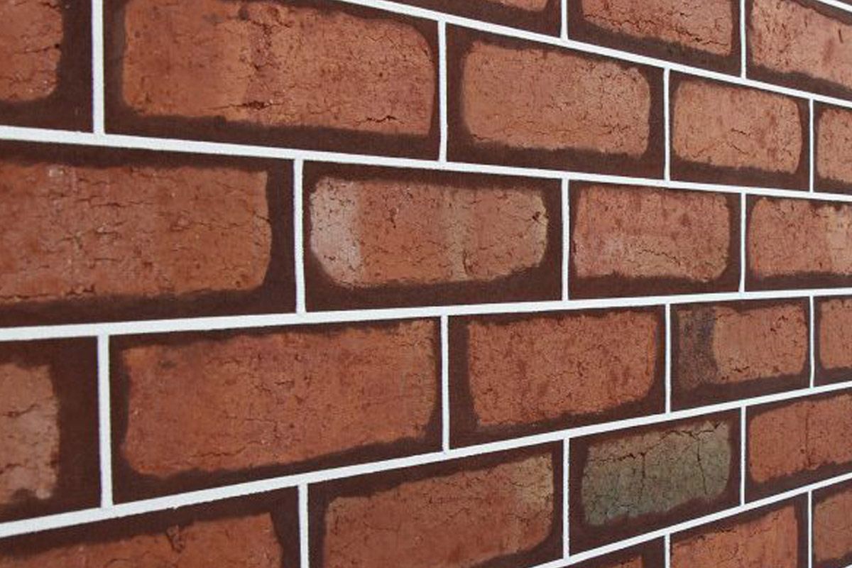 Brick wall with red bricks, white mortar lines, and a slight perspective.