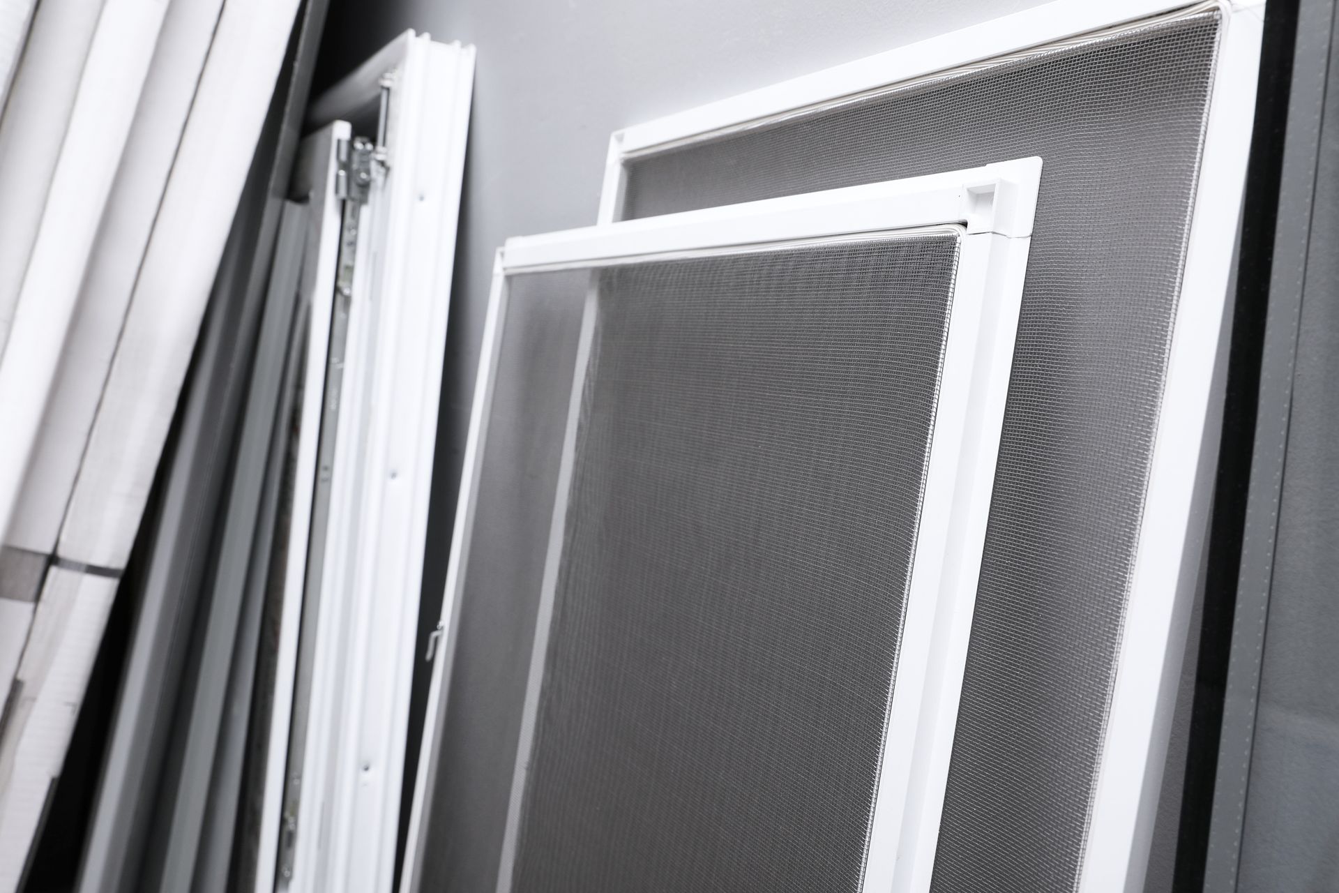 window screens near grey wall