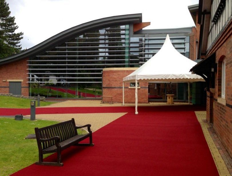 A large building with a white tent in front of it