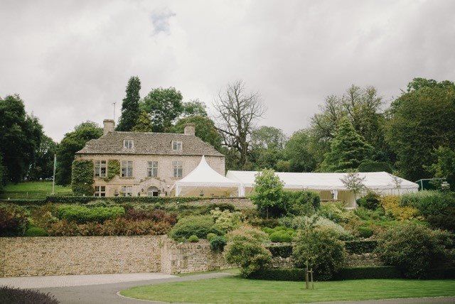 A large house with a white tent in front of it.