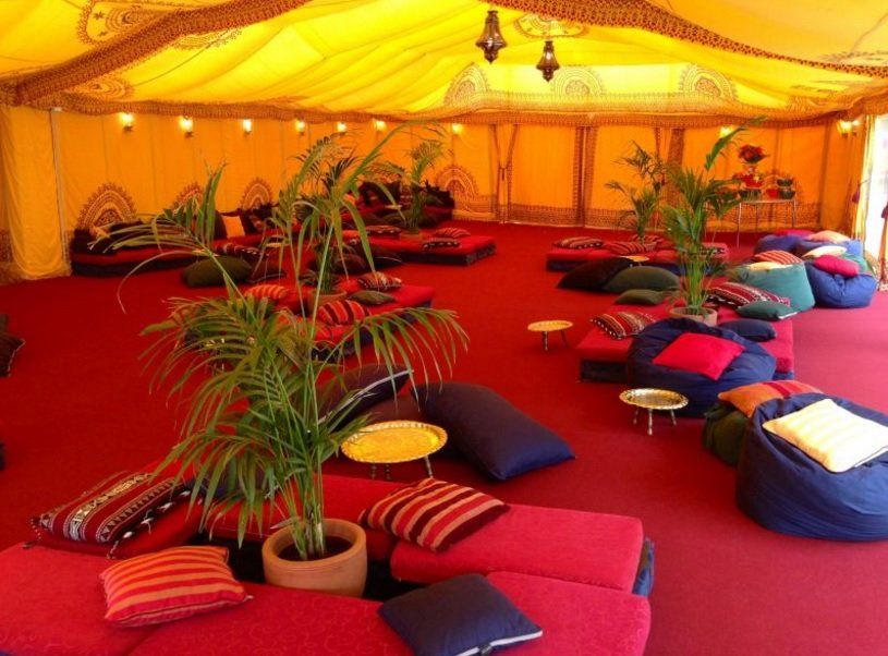 A large room with a lot of pillows and tables