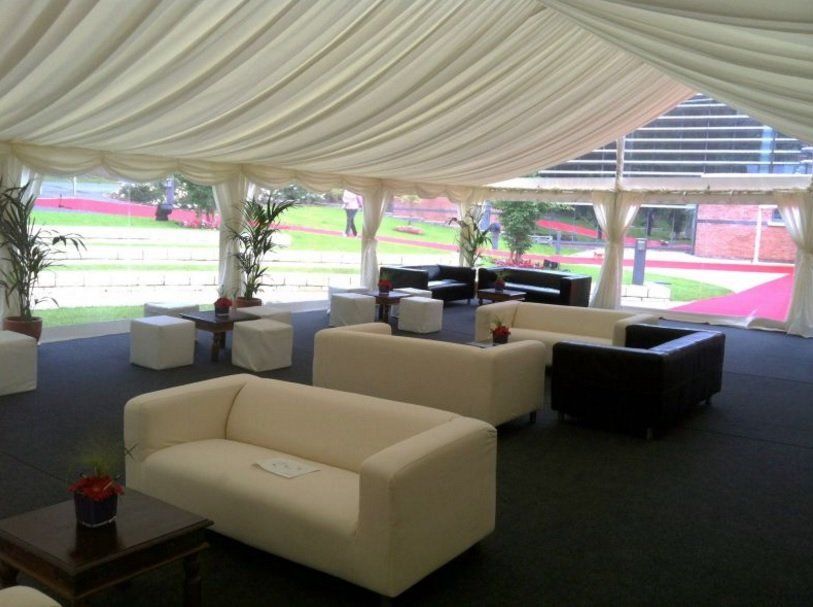 A tent with a lot of furniture inside of it