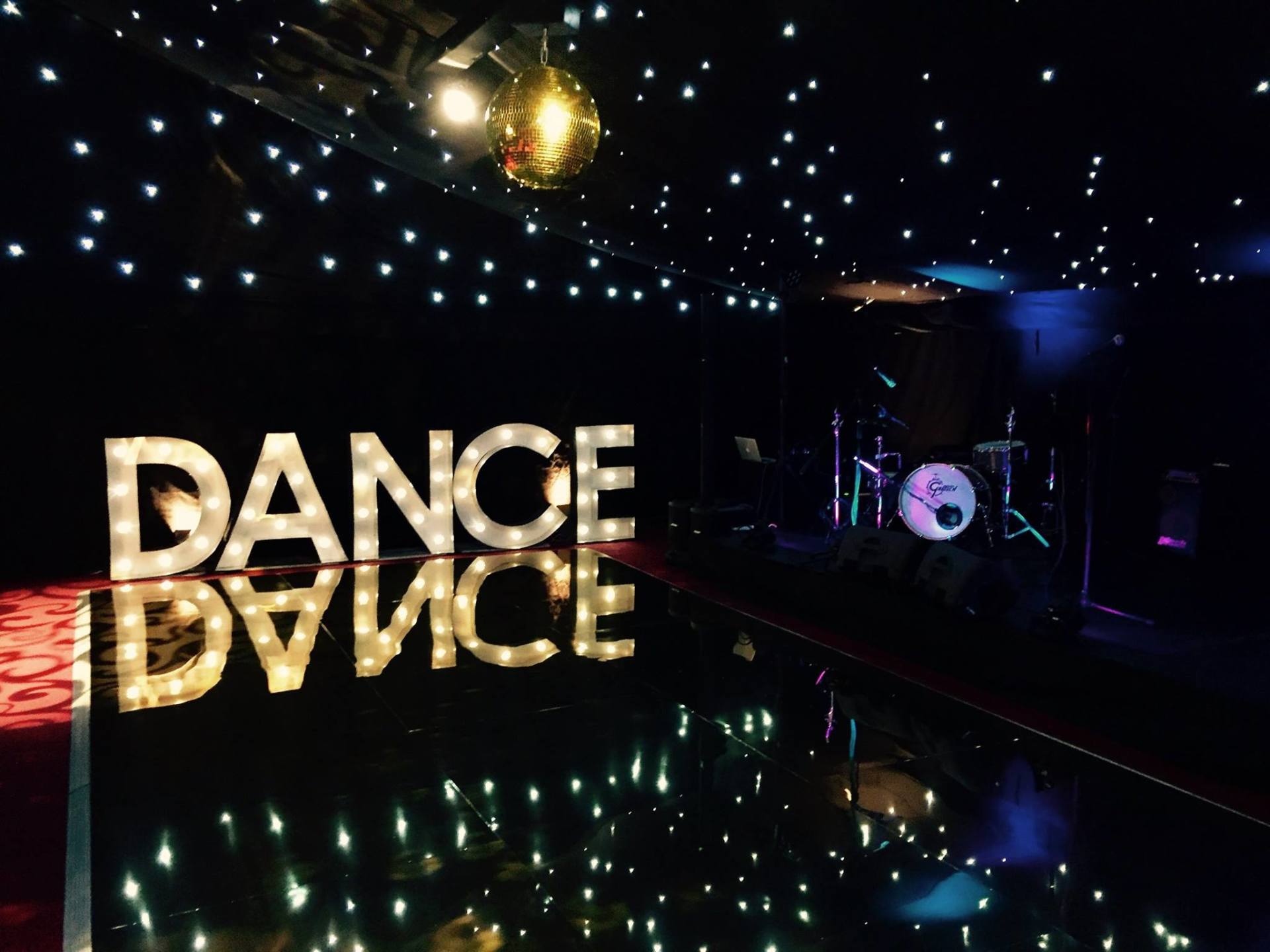A dance advice sign is lit up in a dark room.