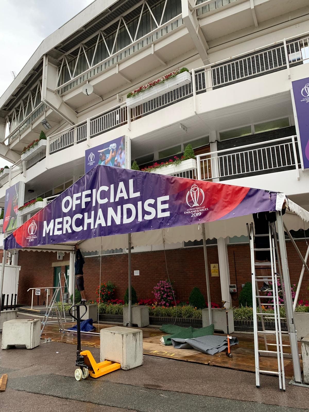 A large building with a sign that says `` official merchandise '' is being built.