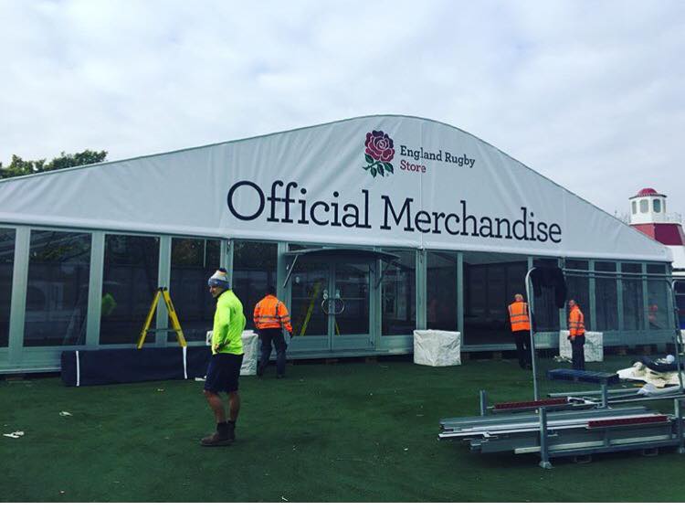 A white tent with the words official merchandise on it