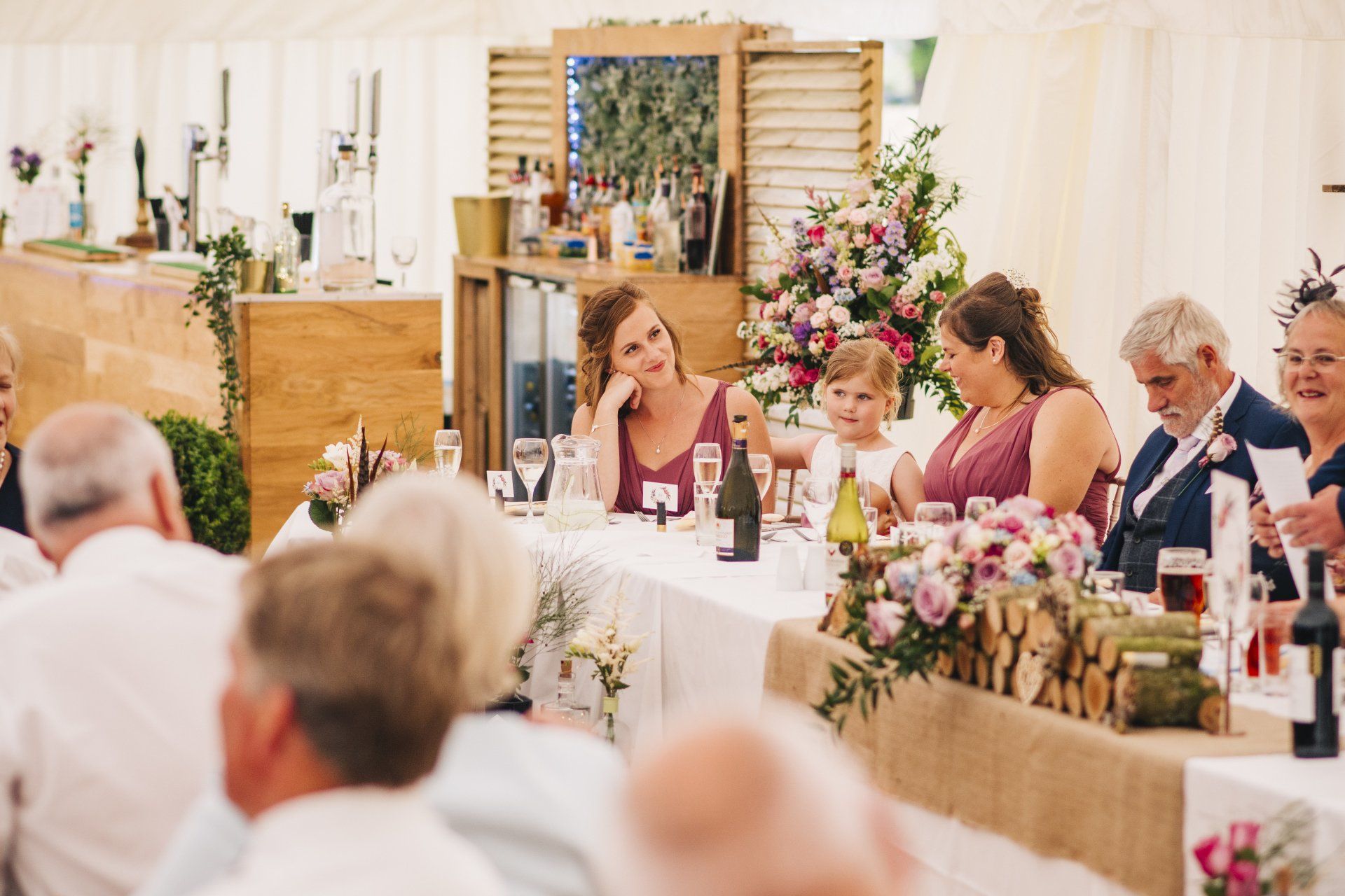 A group of people are sitting at a table at a wedding reception.