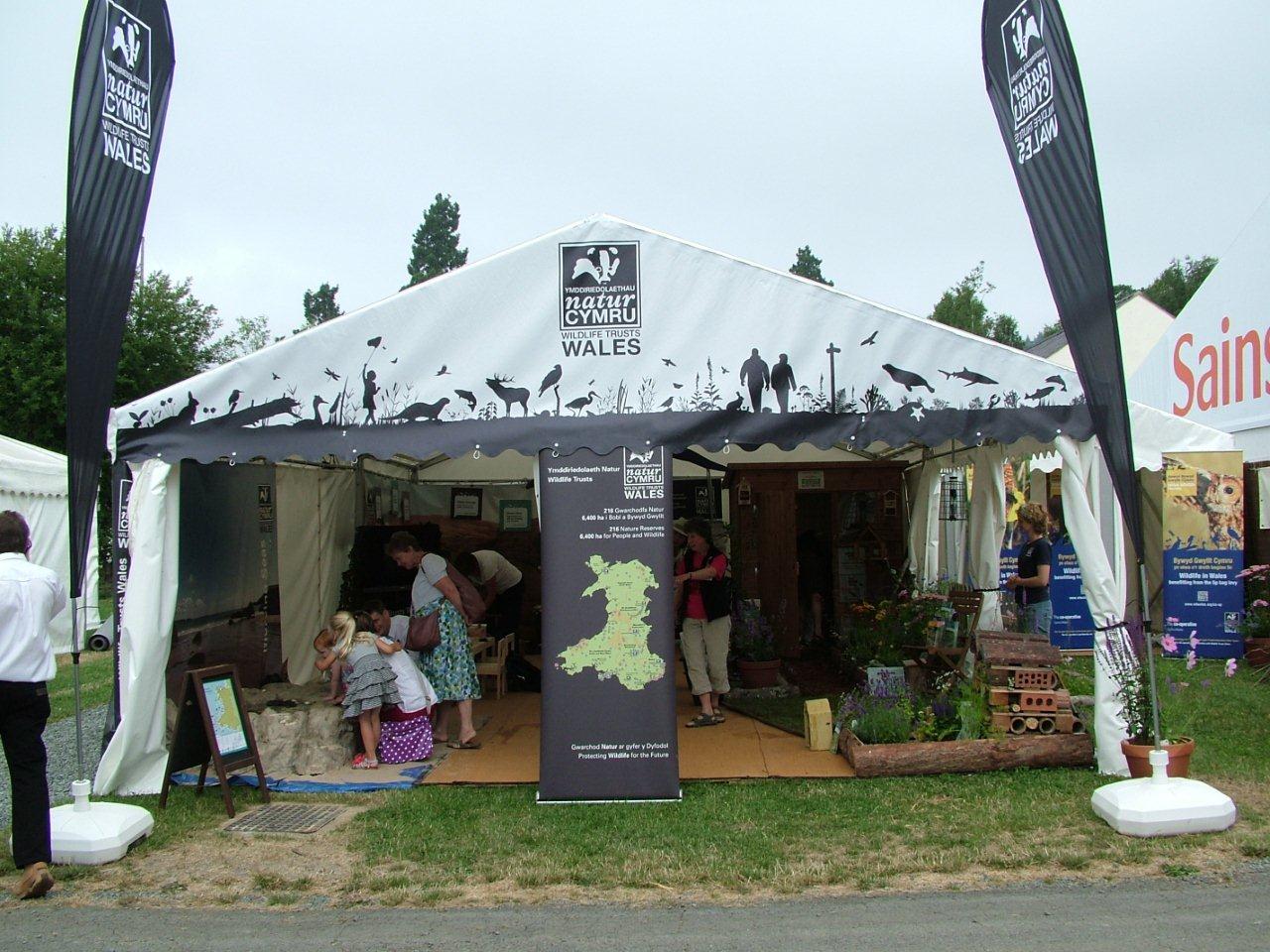 A white tent with a map of wales on it