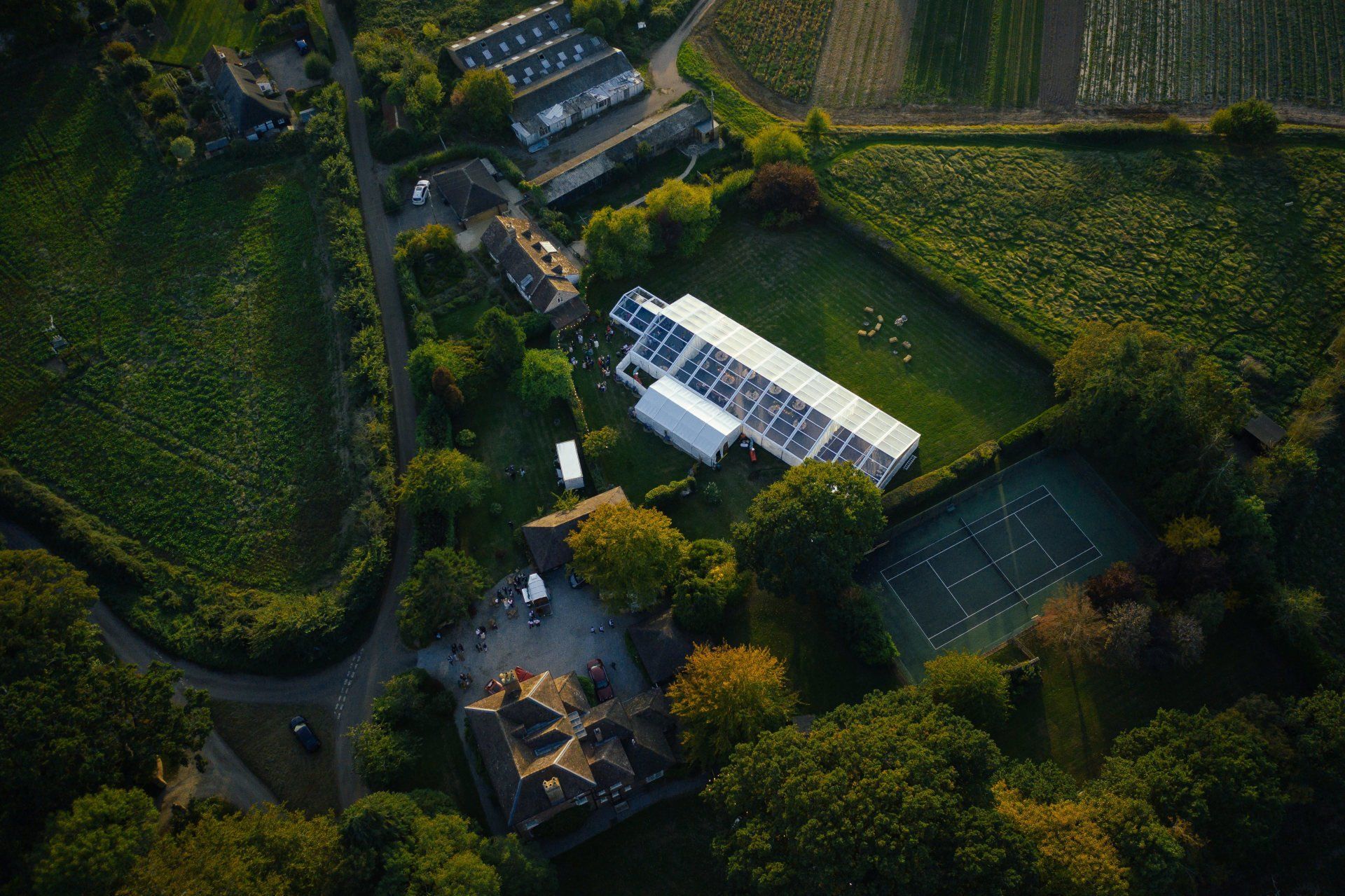 An aerial view of a large tent in the middle of a field.