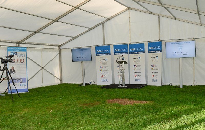 A white tent with a podium in the middle of it
