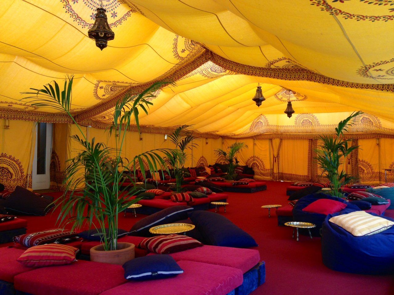 A large tent with lots of couches and tables