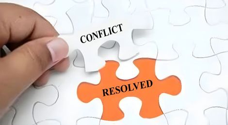 a person is holding a piece of a puzzle that says conflict and resolved