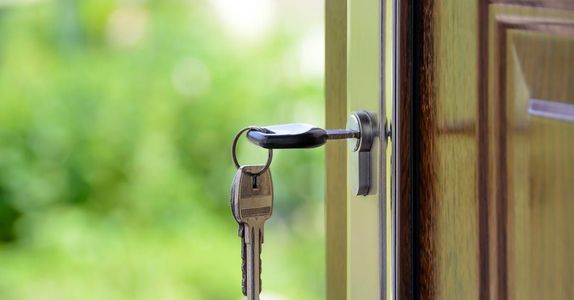 A close up of a key in a door lock.