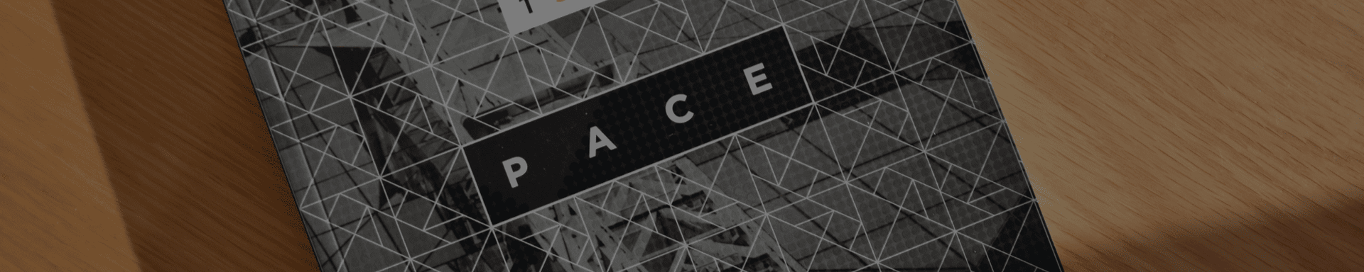 A black and white book is sitting on a wooden table.