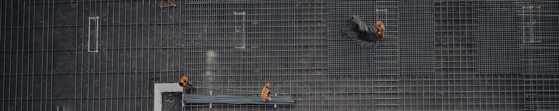 An aerial view of a building under construction in the rain.