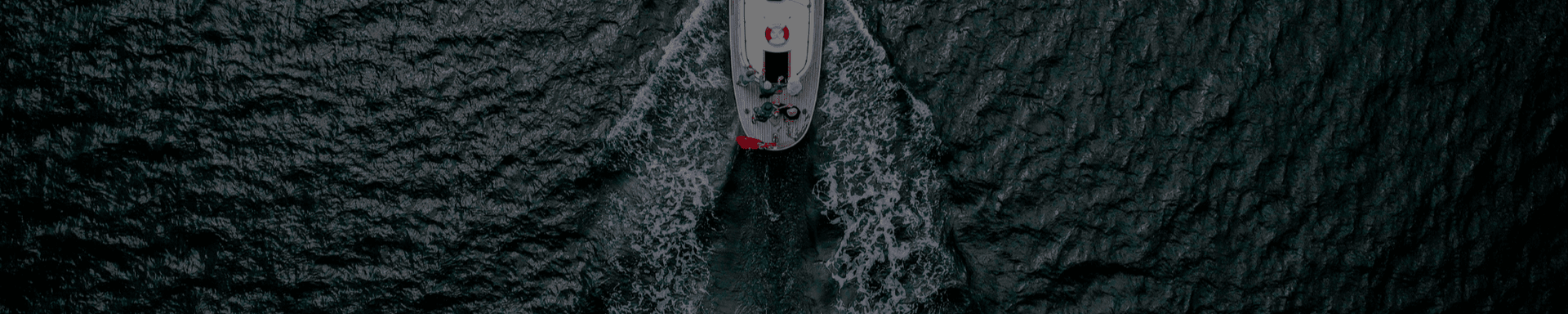 An aerial view of a boat floating on top of a body of water.