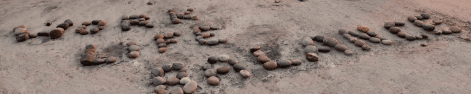 A close up of a concrete surface with a few letters written on it