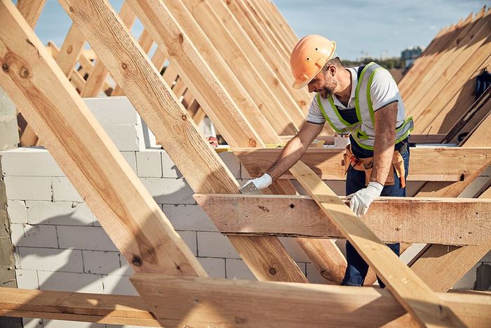 Man Adjusting Metal Corner On Roof