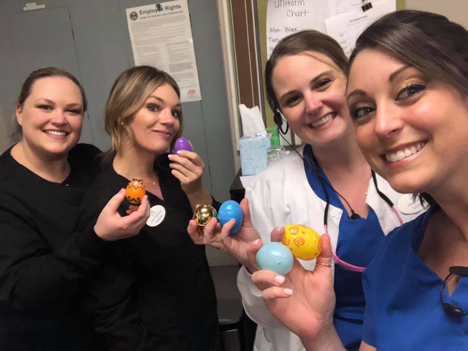 A group of women are holding easter eggs in their hands