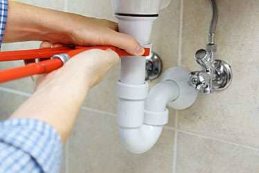 Plumber fixing flood - Plumbing Company in Hyannis, MA