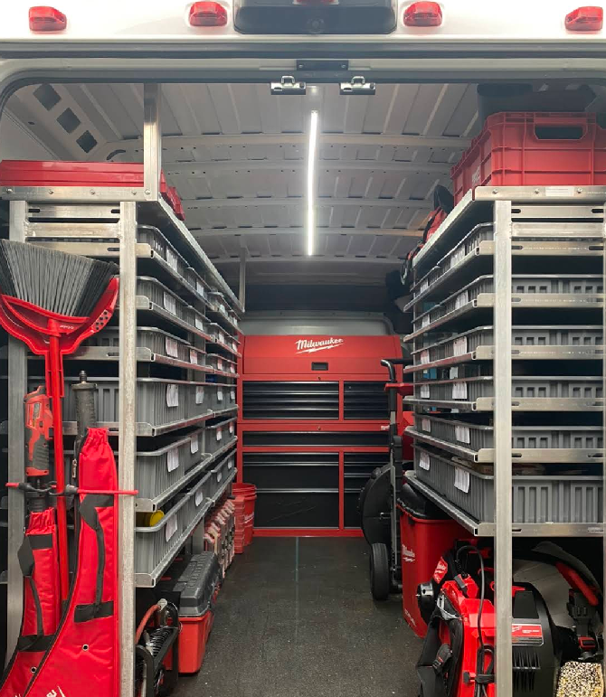 The inside of a van filled with tools and shelves