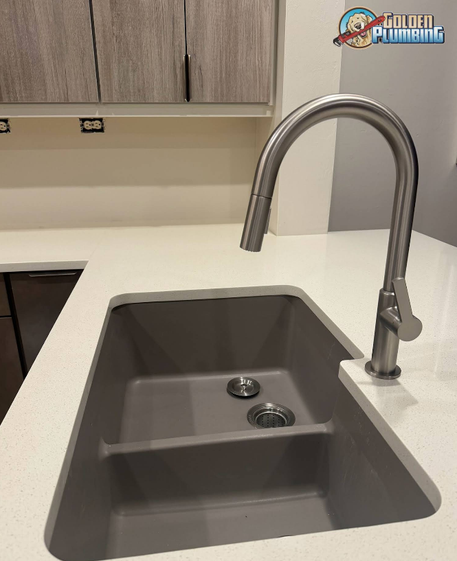 A kitchen sink with two drains and a faucet on a counter.