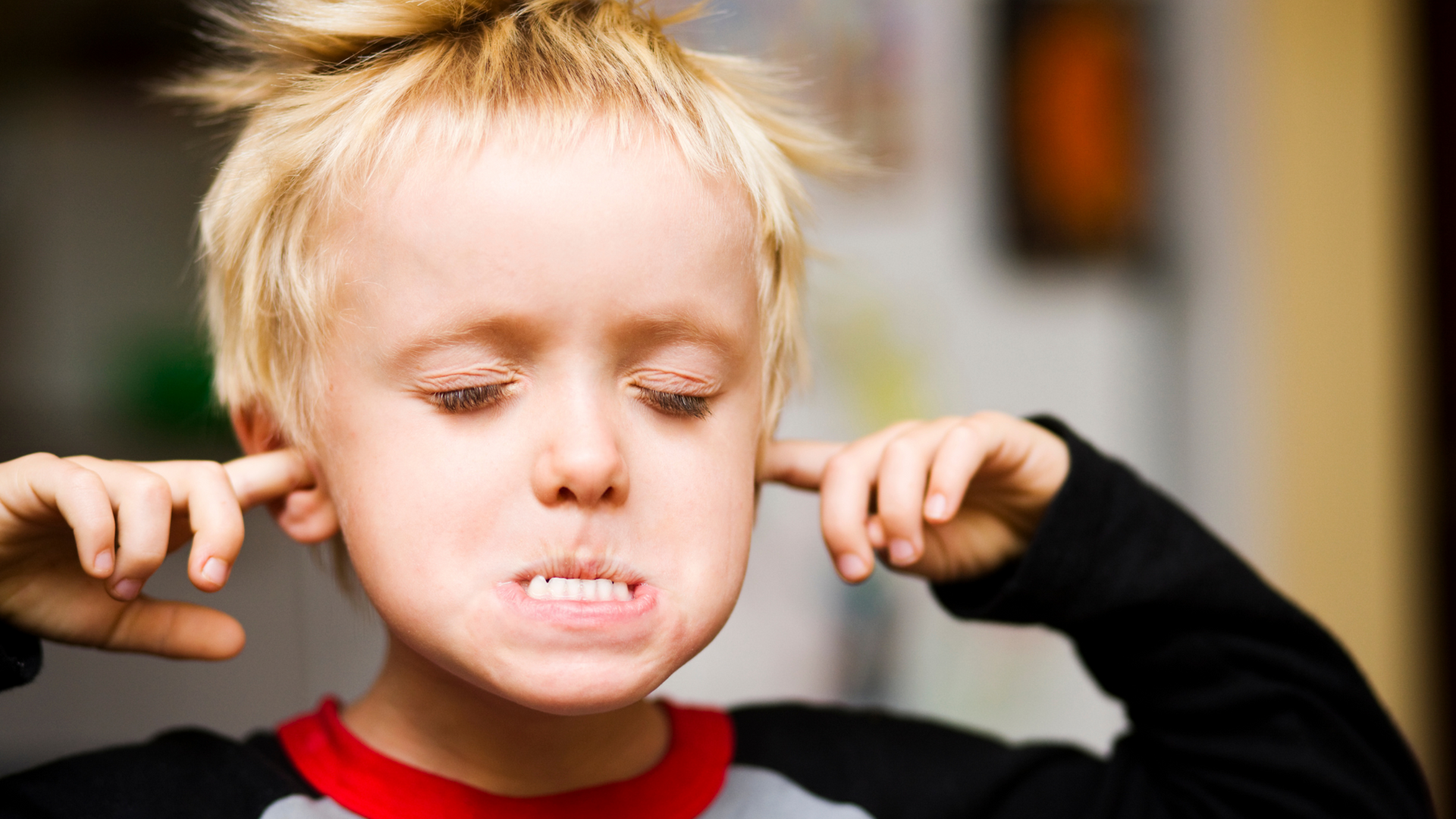 Boy blocking his ears due to a leaking tap noise