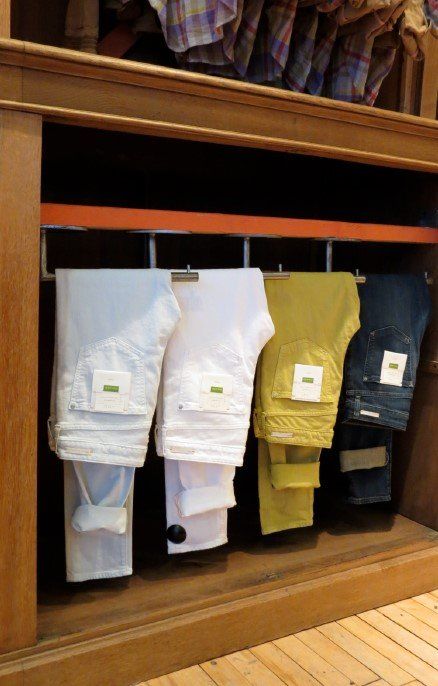 A row of jeans hanging on a rack in a store