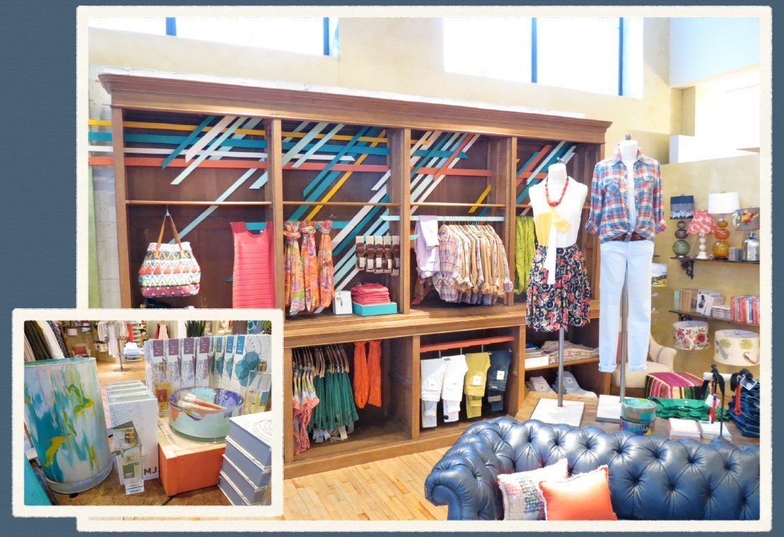 A picture of a clothing store with a blue couch