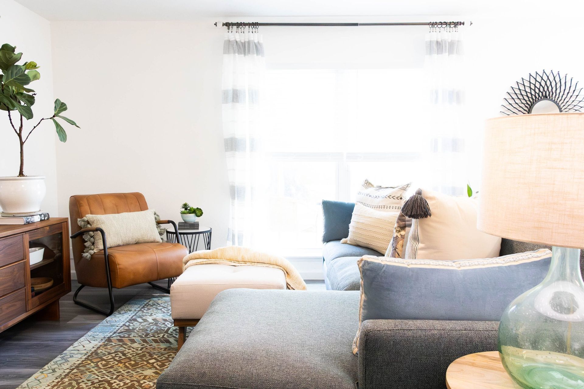 A living room filled with furniture and a large window.