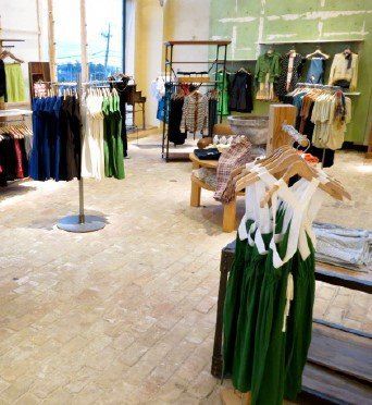 A store with a lot of clothes hanging on racks