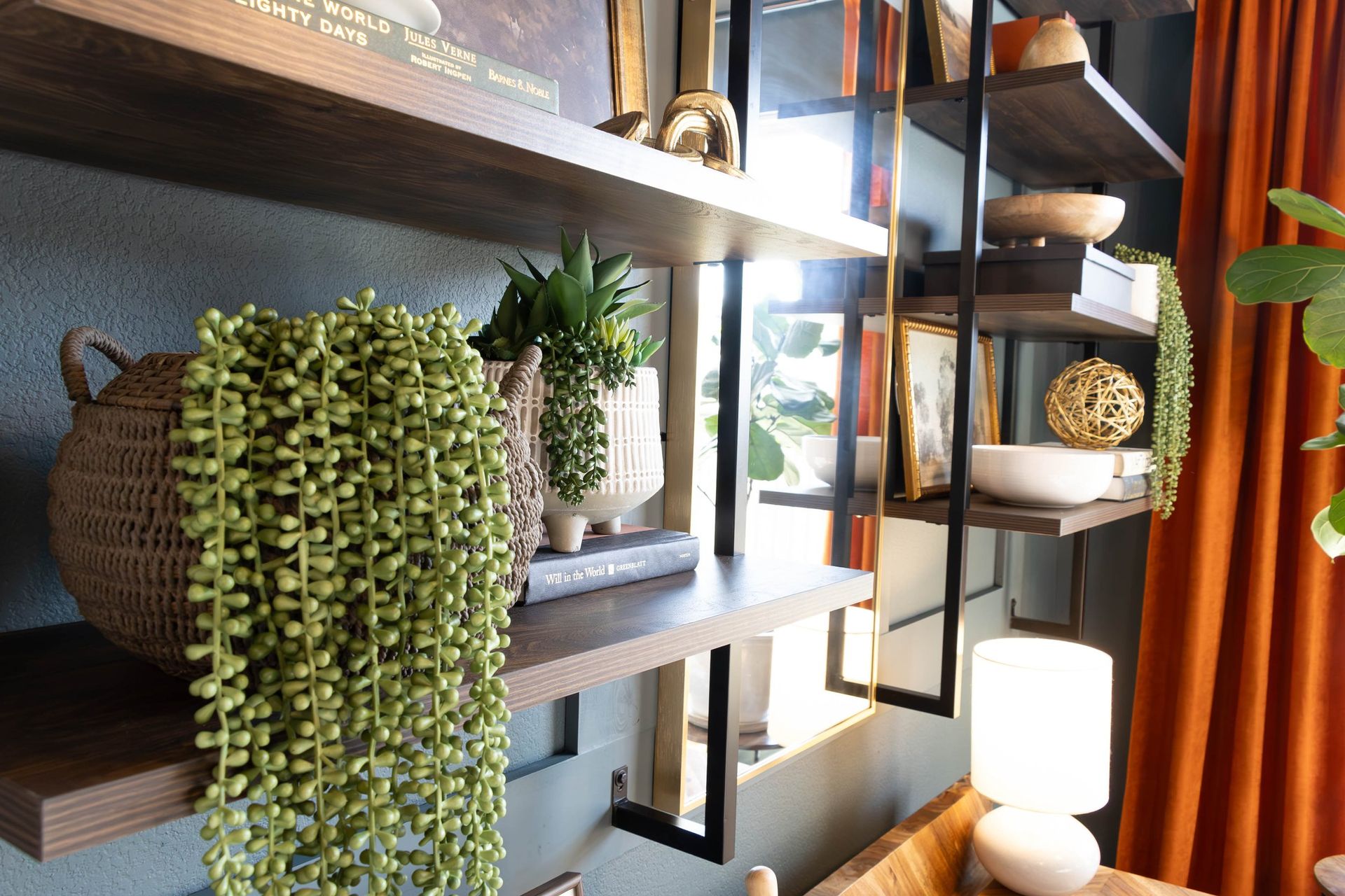 A living room with a lot of shelves and plants on them.