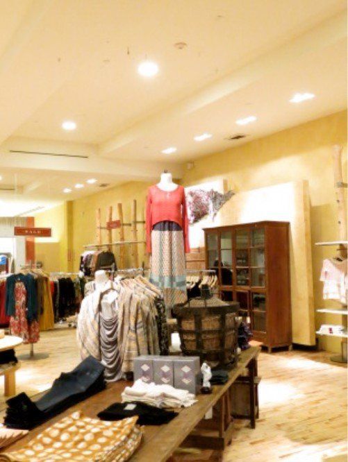 A store with clothes on display including a red top