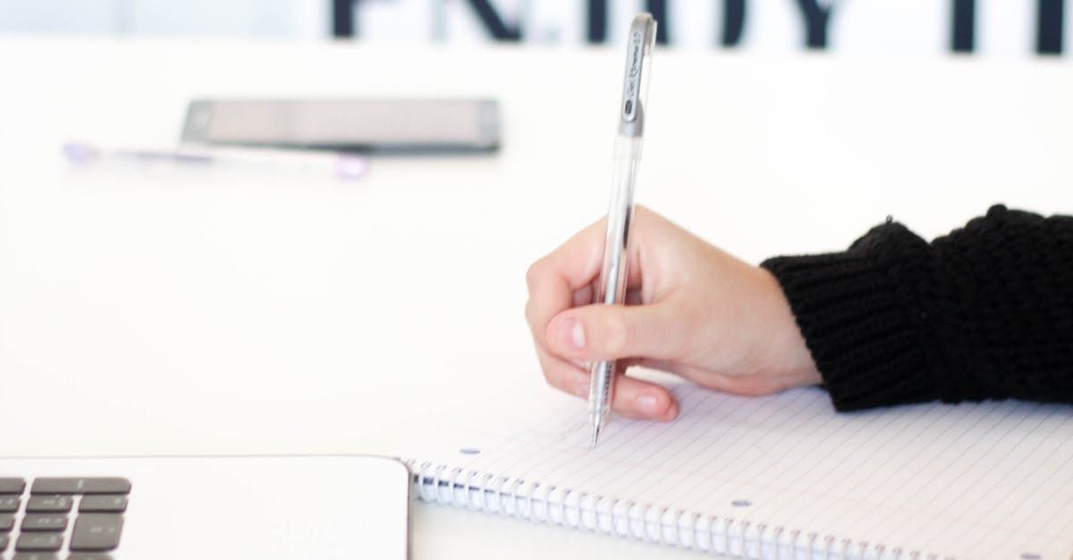 A woman is sitting at a table talking on a cell phone.