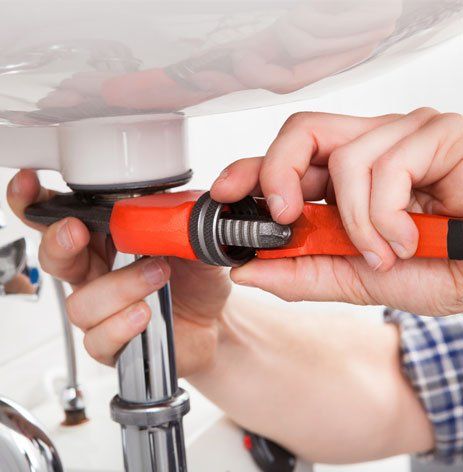 Man Fixing the Sink in Bathroom — Dayton, OH — Bear Plumbing Service