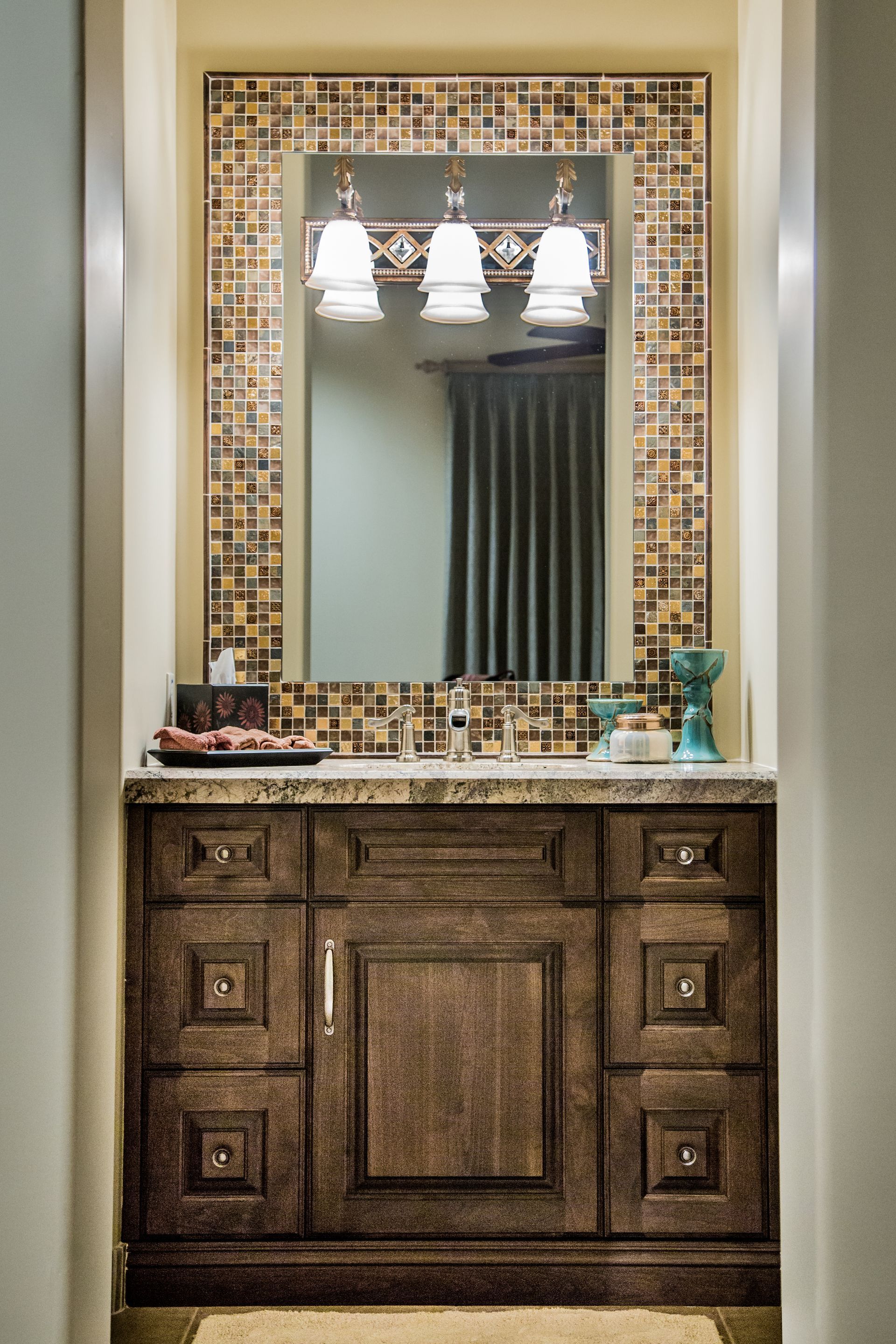 A bathroom vanity with a large mirror above it