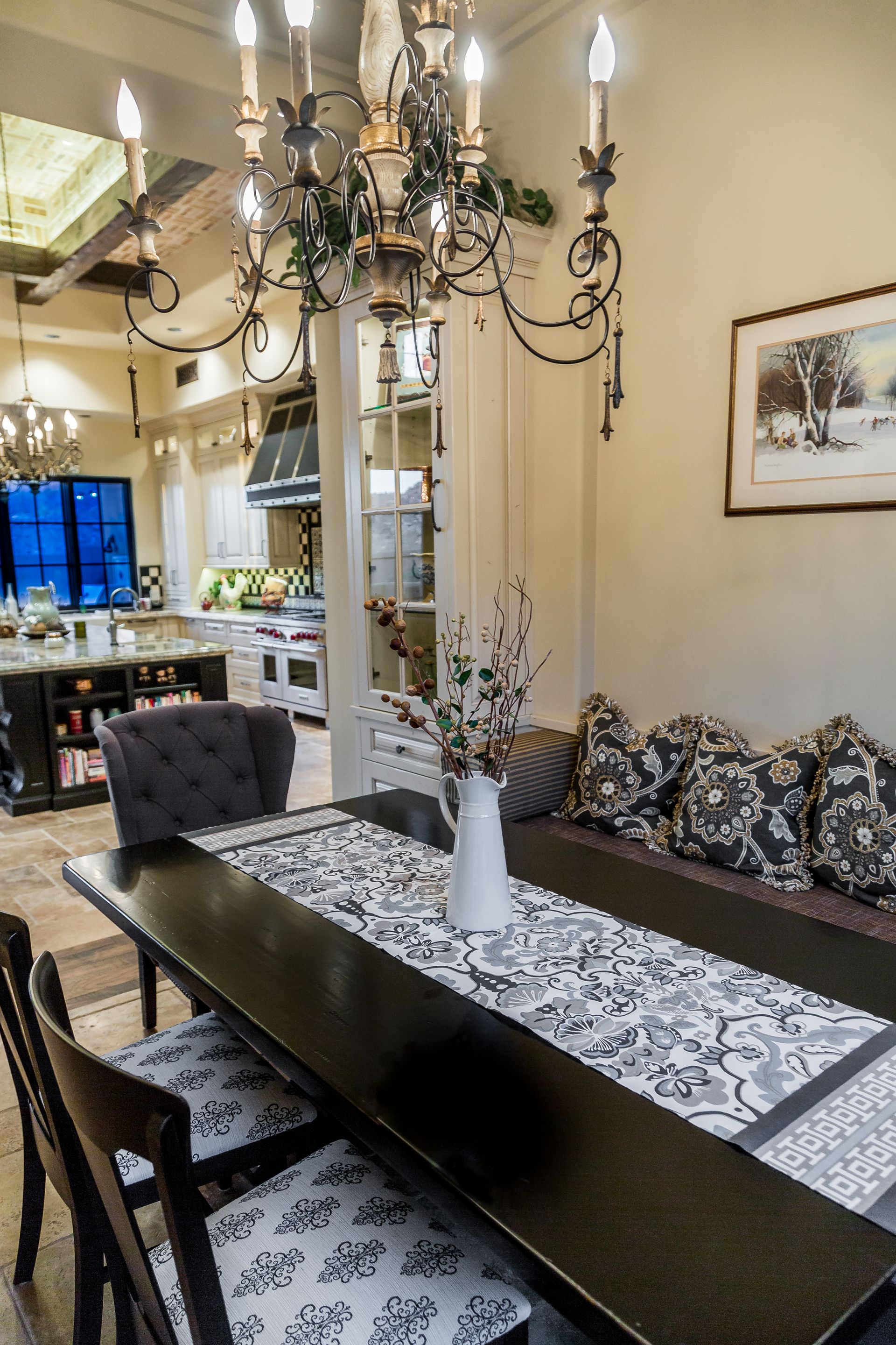 A dining room with a table and chairs and a chandelier.