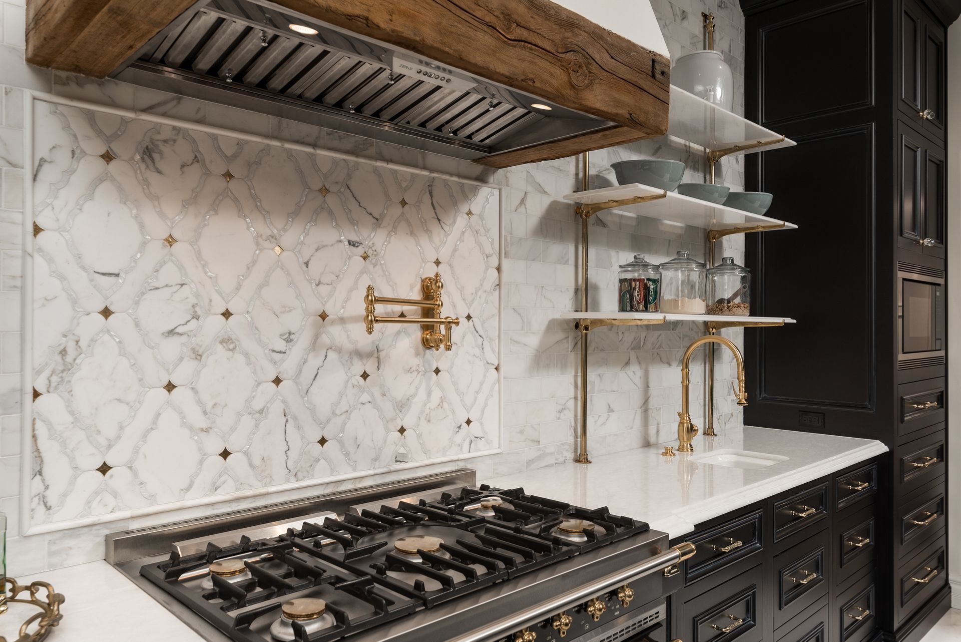 A kitchen with a stove top oven and a wooden hood.