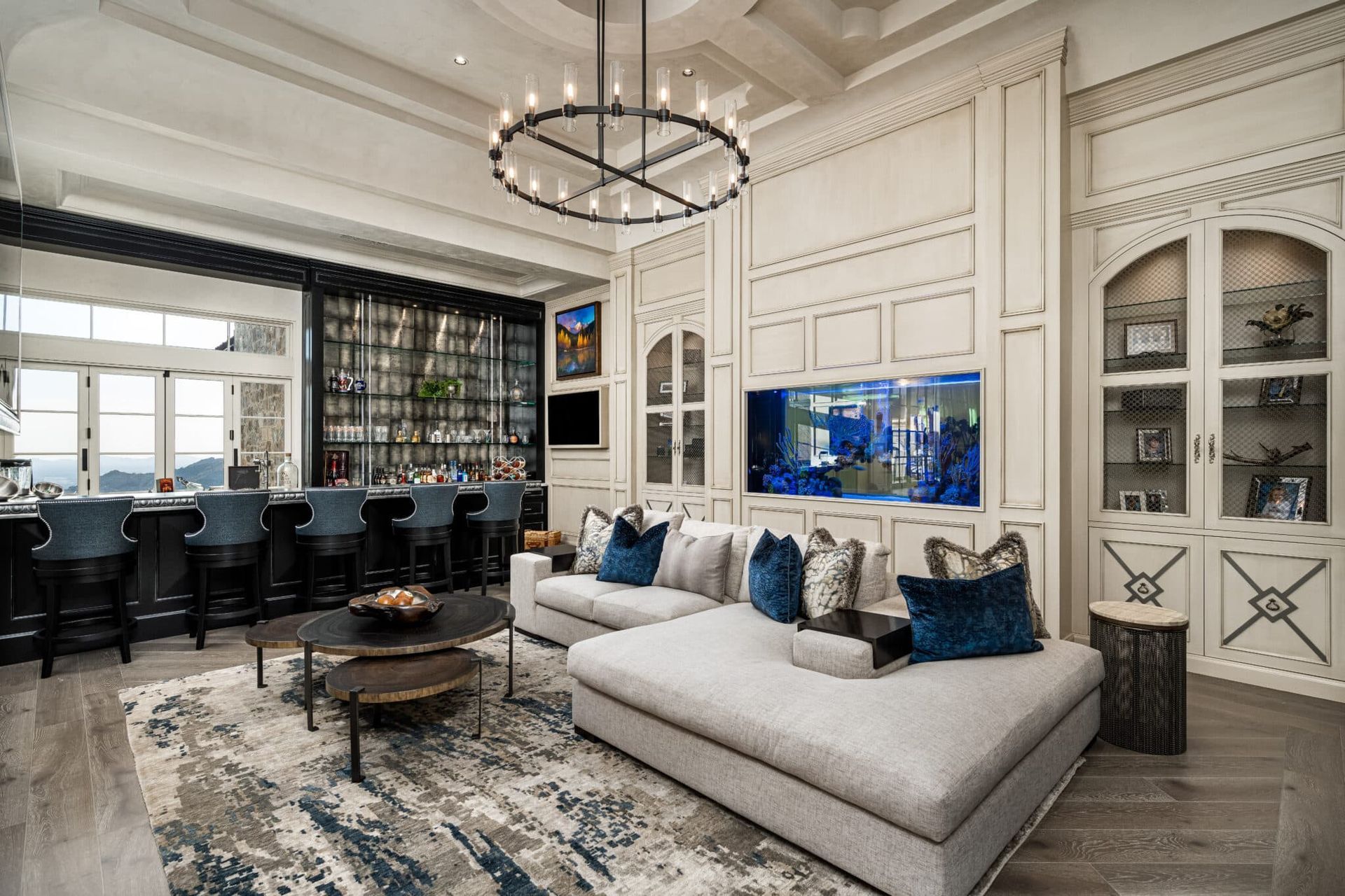 A living room with a couch , table , and aquarium.