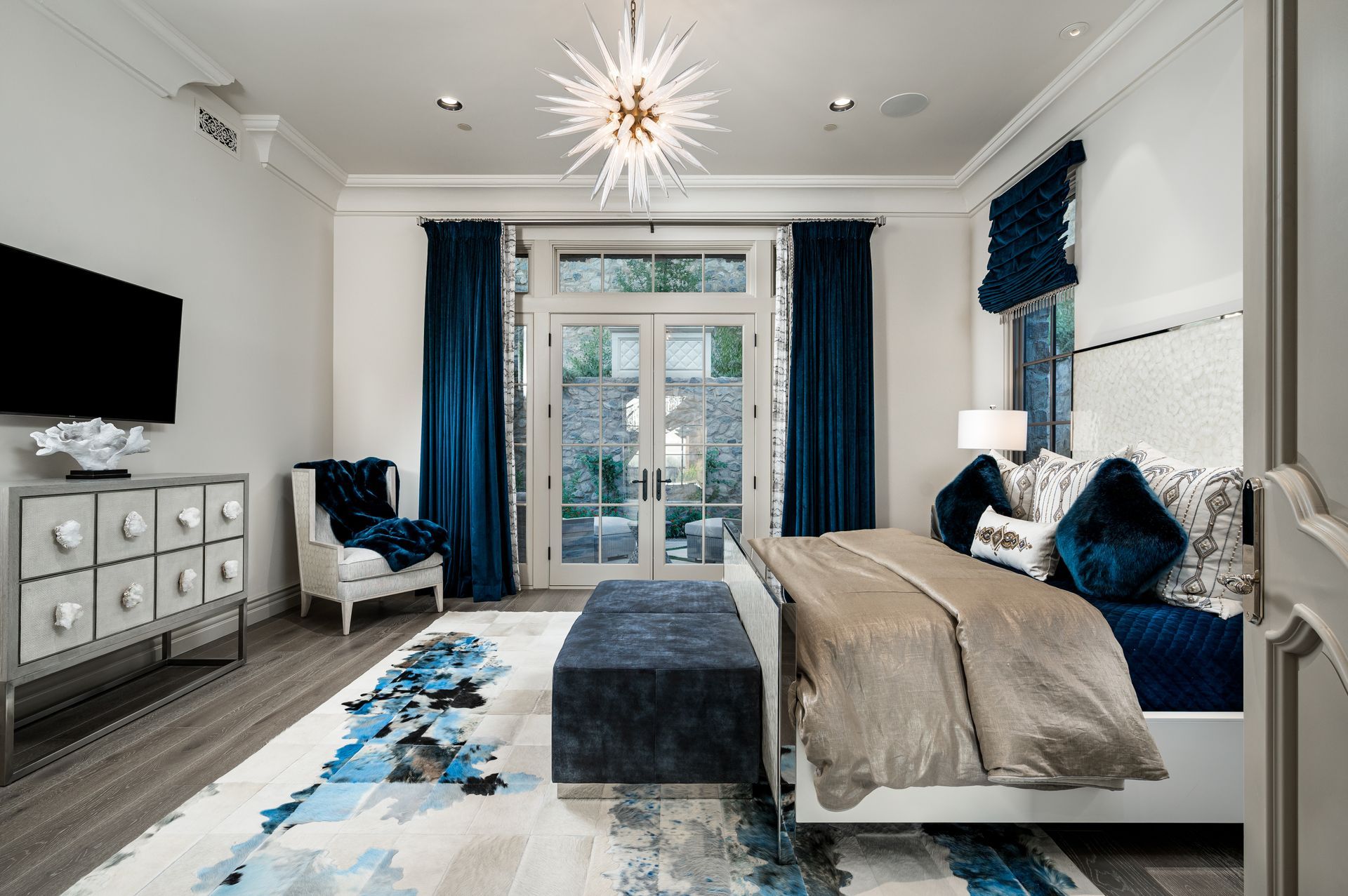 luxury kitchen with wood floors, custom cabinetry and lighting