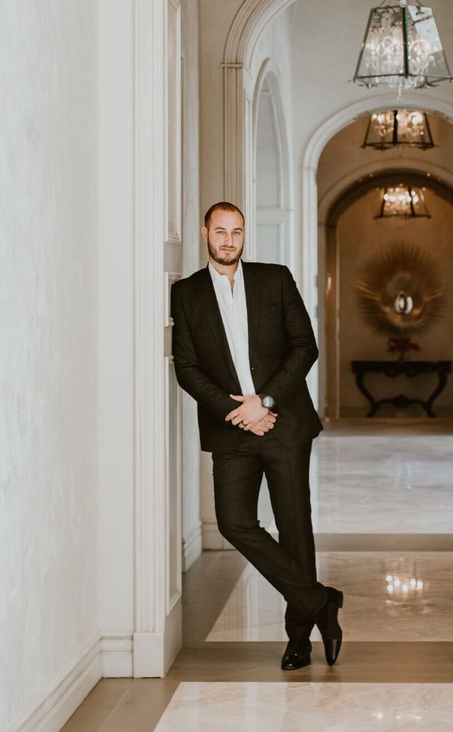 Image of CFO, Angelo standing in a hallway