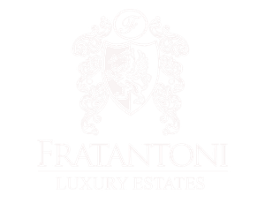 The logo for fratantonio luxury estates is a shield with a lion on it.